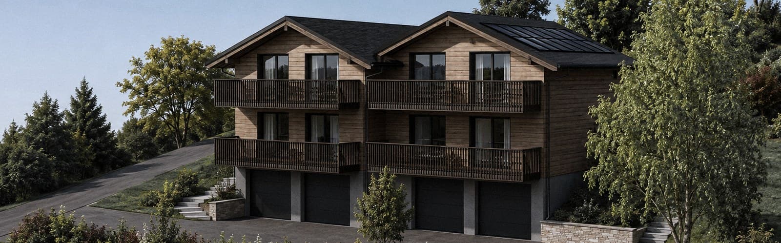 Le projet vu depuis le sud-ouest : les deux chalets mitoyens, quatre appartements repérables sur la façade, balcons filants et quatre portes de garage au socle.