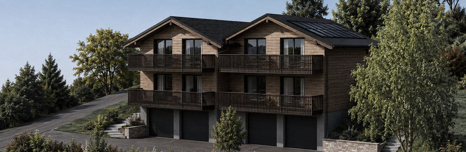 Le projet vu depuis le sud-ouest : les deux chalets mitoyens, quatre appartements repérables sur la façade, balcons filants et quatre portes de garage au socle.